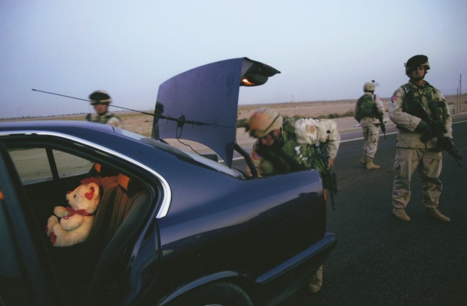 Stephanie Sinclair<br>Members of Charlie Company 1-505, 82nd Airborne, search a suspicious car during a mission to catch a Saddam loyalist in Fallujah, 2003-2006