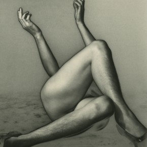 nude person in heels lying down with their legs crossed and hands in the air