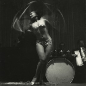 dancing showgirl; band performing behind her