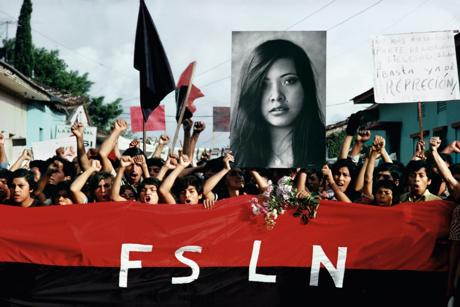 A Funeral procession for assassinated student leaders. Demonstrators carry a photograph of Arlen Siu, a FSLN guerilla fighter killed in the mountains three years earlier, Jinotepe, 1978