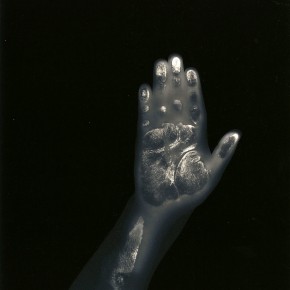 imprint of child's hand against black background