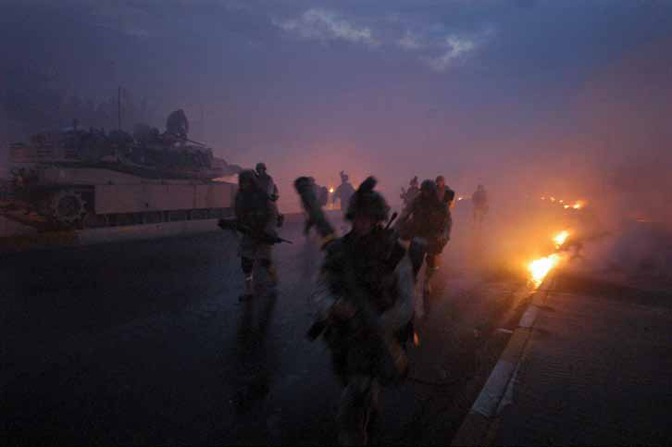 Ashley Gilbertson<br>Marines run for cover after white phosphorus was accidentally fired at them by another company when Bravo Company, 1st Battalion, 8th marine Regiment, was somehow mistaken for a band of insurgents in Falluja, Iraq on November 9, 2004
