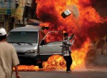 Thumbnail image: Ashley Gilbertson<br>Iraqi’s attempt to extinguish a van that caught fire on Saadoun Street in Baghdad, Iraq on May 30, 2004