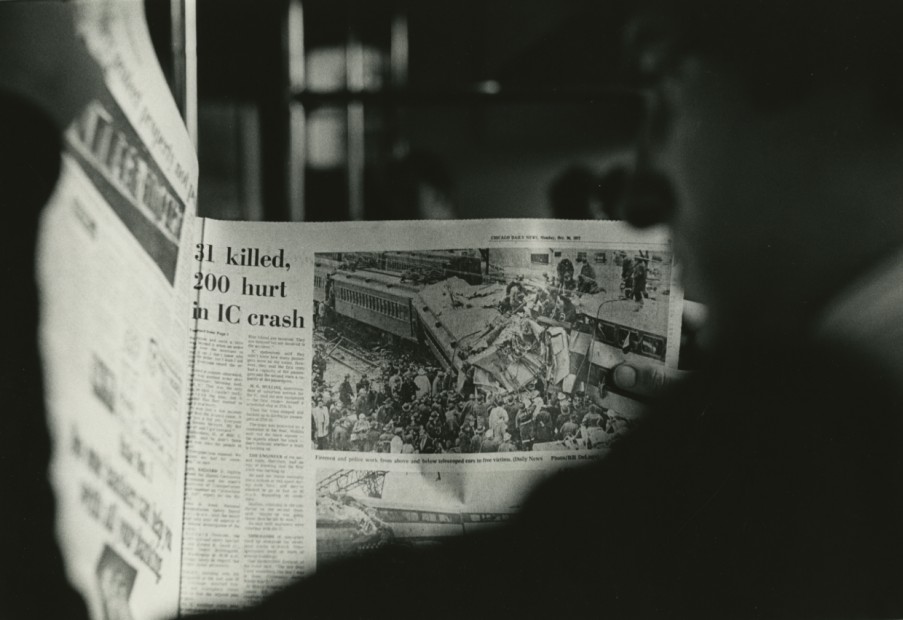 Man Holding Newspaper about Commuter Crash, 1972