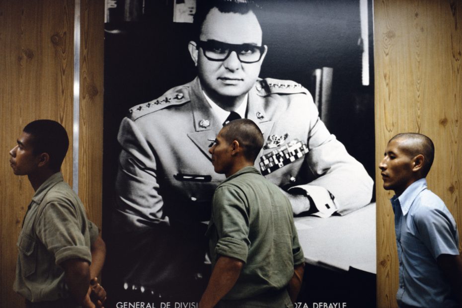 Recruits pass by official portrait of Anastasio Somoza Debayle as president and Commander-in-Chief of the Armed Forces, 1978
