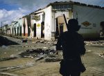 Thumbnail image: Muchacho withdrawing from commercial district of Masaya after three days of bombing, 1978