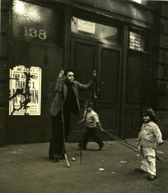 East 26rth Street (Boys with sticks on roller-blades with two young kids, New York City),