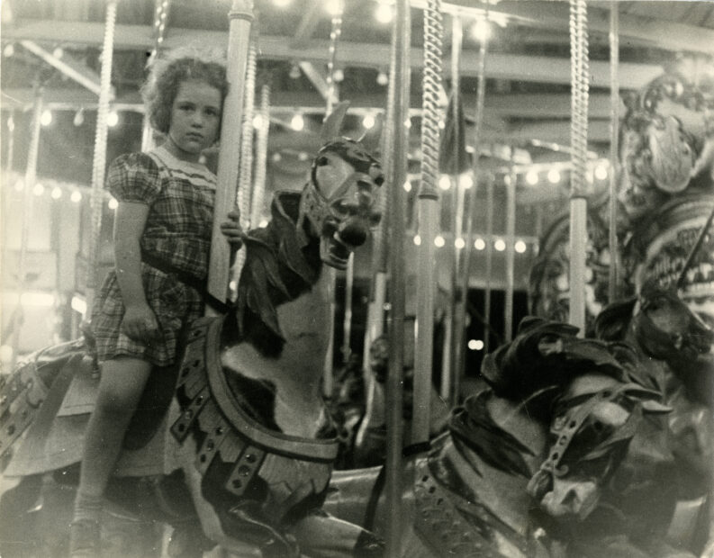 Untitled (girl on carousel horse)