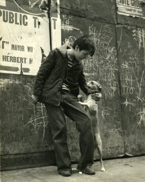 Boy and his dog on the sidewalk, New York City,