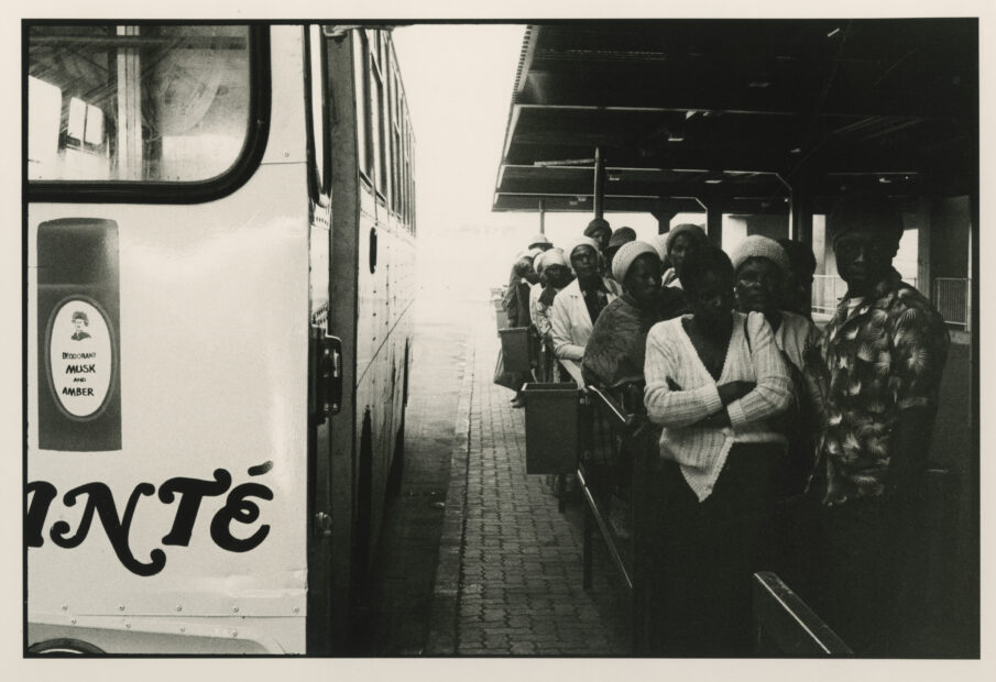 David Goldblatt<br>5:40 A.M.: After arrival at the Marabastedn terminal in Pretoria, many of the passenger from the Wolwekraal bus join other to line up for the local buses that will take them to work in the suburbs and industrial areas of the city,  Some will travel for another hour., 1983